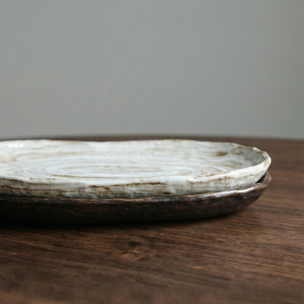 Round ceramic plate on a wooden surface with a gray background
