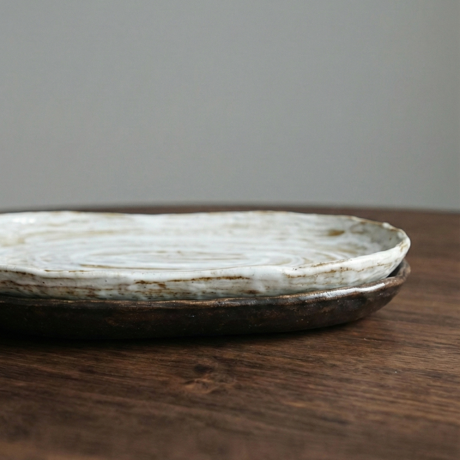 Round ceramic plate on a wooden surface with a gray background