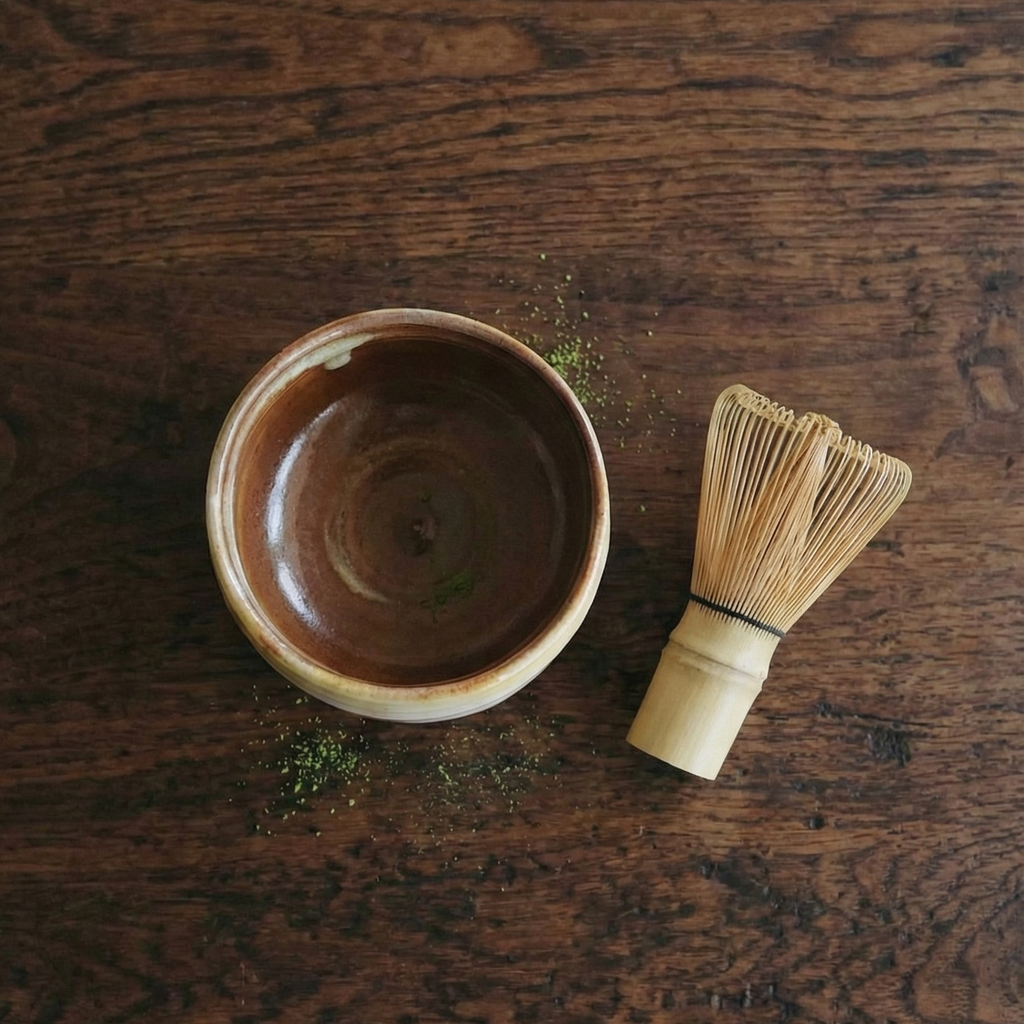 Ceramic bowl and whisk on a wooden surface