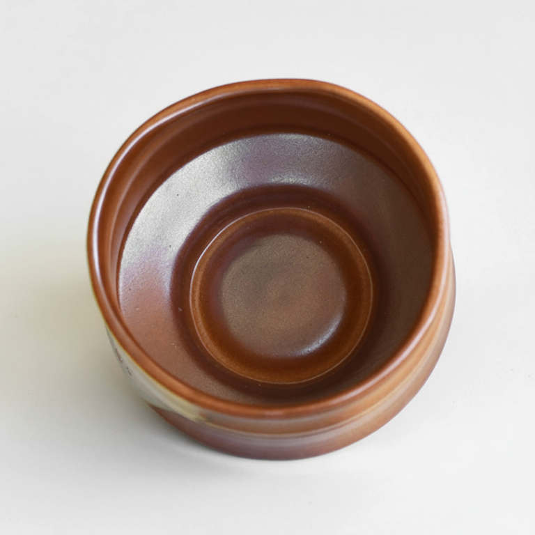 Brown ceramic bowl on a white background