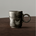 Ceramic mug with a textured surface on a wooden surface