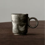 Ceramic mug with a textured surface on a wooden surface